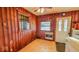 Quaint dining area highlighted by wood paneling and natural light at 2221 Station St, Indianapolis, IN 46218
