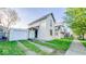Two-story home with simple landscaping, a garage, and proximity to a sidewalk at 2221 Station St, Indianapolis, IN 46218