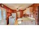 Compact kitchen shows wood paneling, standard appliances, and an adjacent area at 2221 Station St, Indianapolis, IN 46218