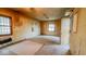 A living room featuring wood trim, radiator, and a ceiling fan at 2221 Station St, Indianapolis, IN 46218