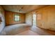 A living room featuring a window, wood trim, and an exterior door at 2221 Station St, Indianapolis, IN 46218