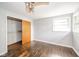 Open, empty bedroom featuring wood floors, ceiling fan and a window at 2319 E 40Th St, Anderson, IN 46013