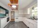 Functional kitchen with white cabinets, countertops, ample storage, and laundry nook at 2319 E 40Th St, Anderson, IN 46013