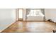Spacious living room with hardwood floors and a large window offering ample natural light at 2319 E 40Th St, Anderson, IN 46013