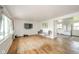 Bright living room with hardwood floors, large windows, and an open layout connected to the kitchen at 2319 E 40Th St, Anderson, IN 46013