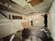 Reveals a partially finished basement with visible garage door, awaiting complete refurbishment at 2337 N Webster N Ave, Indianapolis, IN 46219