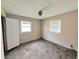 Bright bedroom with bare floors, awaiting renovation, two windows and a door frame offer a spacious design opportunity at 2337 N Webster N Ave, Indianapolis, IN 46219