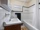 Clean bathroom with white tile, dark accents and a tub at 2399 E Mckay Rd, Shelbyville, IN 46176