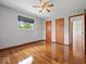 Bedroom featuring hardwood floors, ceiling fan, and two closets at 2399 E Mckay Rd, Shelbyville, IN 46176
