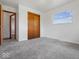 Bedroom featuring carpeting, a closet, and a bright window with natural light at 2399 E Mckay Rd, Shelbyville, IN 46176