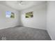 This bedroom features neutral colors, two windows, and soft gray carpeting at 2399 E Mckay Rd, Shelbyville, IN 46176