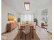 Sunlit dining room with modern light fixture, tiled floor and connection to living room at 2399 E Mckay Rd, Shelbyville, IN 46176