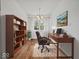 Home office featuring wood floors, desk, and a bookshelf at 2399 E Mckay Rd, Shelbyville, IN 46176