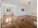 Open-concept living room featuring gleaming hardwood floors, neutral walls, and natural light at 2399 E Mckay Rd, Shelbyville, IN 46176