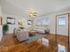 Bright living room with polished hardwood floors, ceiling fan, and stylish furniture at 2399 E Mckay Rd, Shelbyville, IN 46176