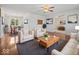Open-concept living room featuring hardwood floors, neutral walls, stylish decor, and natural light at 2399 E Mckay Rd, Shelbyville, IN 46176