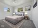 Stylish main bedroom featuring a gray color palette, carpet, and natural light at 2399 E Mckay Rd, Shelbyville, IN 46176
