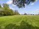 Sprawling green yard with views of the home, other outbuildings and mature trees at 2399 E Mckay Rd, Shelbyville, IN 46176