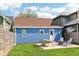 Charming blue home with a backyard featuring a patio set and fire pit for outdoor enjoyment at 253 E Minnesota St, Indianapolis, IN 46225