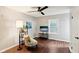 Bedroom featuring stylish decor, hardwood floors, a ceiling fan, and a comfortable chair at 253 E Minnesota St, Indianapolis, IN 46225