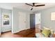 Bedroom with a chair, hardwood floors, multiple doors, a ceiling fan and natural light from a window at 253 E Minnesota St, Indianapolis, IN 46225
