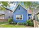 Attractive exterior showcasing the home's blue siding, landscaping, and classic architectural details at 253 E Minnesota St, Indianapolis, IN 46225