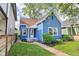 Inviting exterior view showcasing the home's entryway, blue siding, and well-kept landscaping at 253 E Minnesota St, Indianapolis, IN 46225