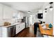 Modern kitchen with stainless steel appliances, white cabinets, and breakfast bar at 253 E Minnesota St, Indianapolis, IN 46225