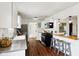 Modern kitchen with stainless steel appliances, white cabinets, and convenient breakfast bar at 253 E Minnesota St, Indianapolis, IN 46225