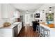 Modern kitchen with stainless steel appliances, white cabinets, and breakfast bar at 253 E Minnesota St, Indianapolis, IN 46225