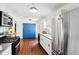 Charming kitchen featuring stainless steel appliances, white cabinetry, and striking blue sliding doors at 253 E Minnesota St, Indianapolis, IN 46225