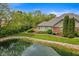 Manicured backyard with private pond and mature trees at 2726 Reflection Way, Greenwood, IN 46143