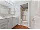 Bathroom with double sink vanity, large mirror, and shower with glass doors at 2726 Reflection Way, Greenwood, IN 46143