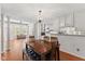 Dining area open to the living room with stylish chandelier and white cabinetry at 2726 Reflection Way, Greenwood, IN 46143