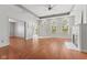 Bright living room featuring hardwood floors, tray ceiling, arched windows, and inviting fireplace at 2726 Reflection Way, Greenwood, IN 46143