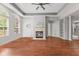 Bright living room featuring tray ceiling, modern fireplace, neutral color palette, and rich hardwood floors at 2726 Reflection Way, Greenwood, IN 46143