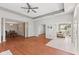 Open-concept living space featuring hardwood floors, tray ceiling, and seamless flow to the dining and sunroom at 2726 Reflection Way, Greenwood, IN 46143