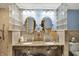 An elegant bathroom highlighting a glass block accent wall, dual sinks with granite countertops at 2769 S 800 W, Indianapolis, IN 46239