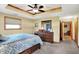 Comfortable bedroom showcasing neutral walls, a ceiling fan, and an attached bathroom through a doorway at 2769 S 800 W, Indianapolis, IN 46239
