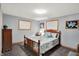 Tranquil bedroom boasting soft blue walls, wooden trim windows, and a spacious layout at 2769 S 800 W, Indianapolis, IN 46239
