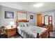 Inviting bedroom featuring soft blue walls, wood trim windows, carpet flooring, and a comfortable bed at 2769 S 800 W, Indianapolis, IN 46239