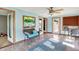 Bright sunroom with large windows, comfortable seating, and a ceiling fan, perfect for enjoying the outdoors indoors at 2769 S 800 W, Indianapolis, IN 46239