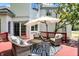 Inviting back deck with wicker seating, stylish outdoor rug, and relaxing umbrella at 3162 Hazel Foster Dr, Carmel, IN 46033