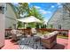Inviting back deck with wicker seating, stylish outdoor rug, and relaxing umbrella at 3162 Hazel Foster Dr, Carmel, IN 46033