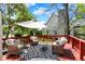 Inviting back deck with wicker seating, stylish outdoor rug, and relaxing umbrella at 3162 Hazel Foster Dr, Carmel, IN 46033