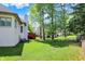 Spacious backyard featuring a well-manicured lawn and a charming red-toned deck at 3162 Hazel Foster Dr, Carmel, IN 46033