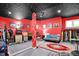 Red-walled basement space features recording and lounge spaces at 3162 Hazel Foster Dr, Carmel, IN 46033