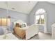 Cozy bedroom features a vaulted ceiling, arched window and comfy white bed with colorful pillows at 3162 Hazel Foster Dr, Carmel, IN 46033