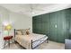 Guest bedroom boasts dark green accent wall, modern dresser, and a queen bed at 3162 Hazel Foster Dr, Carmel, IN 46033