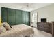 Guest bedroom boasts dark green accent wall, modern dresser, and a queen bed at 3162 Hazel Foster Dr, Carmel, IN 46033